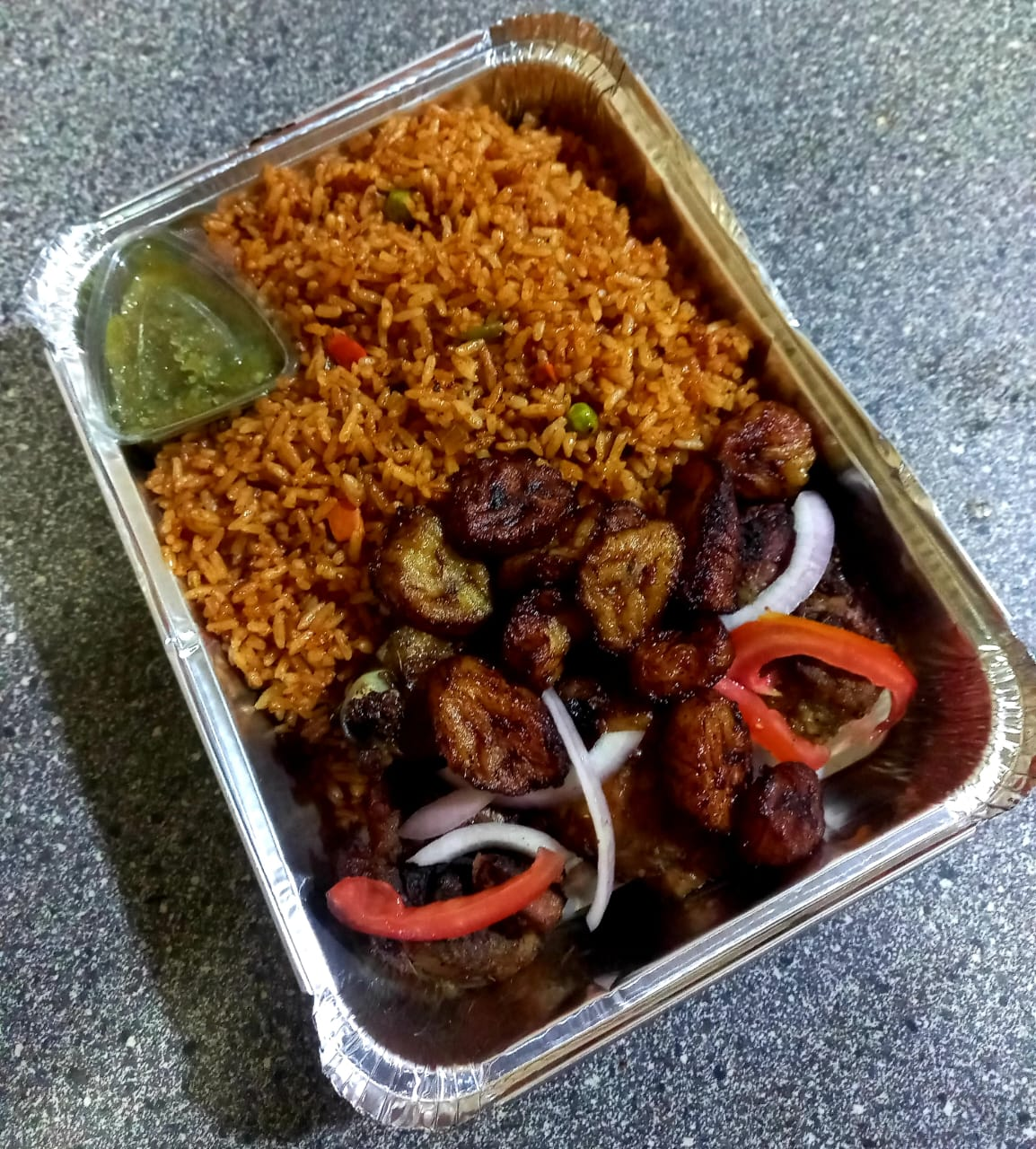 Jollof rice with grilled chicken and plantain from the kitchen