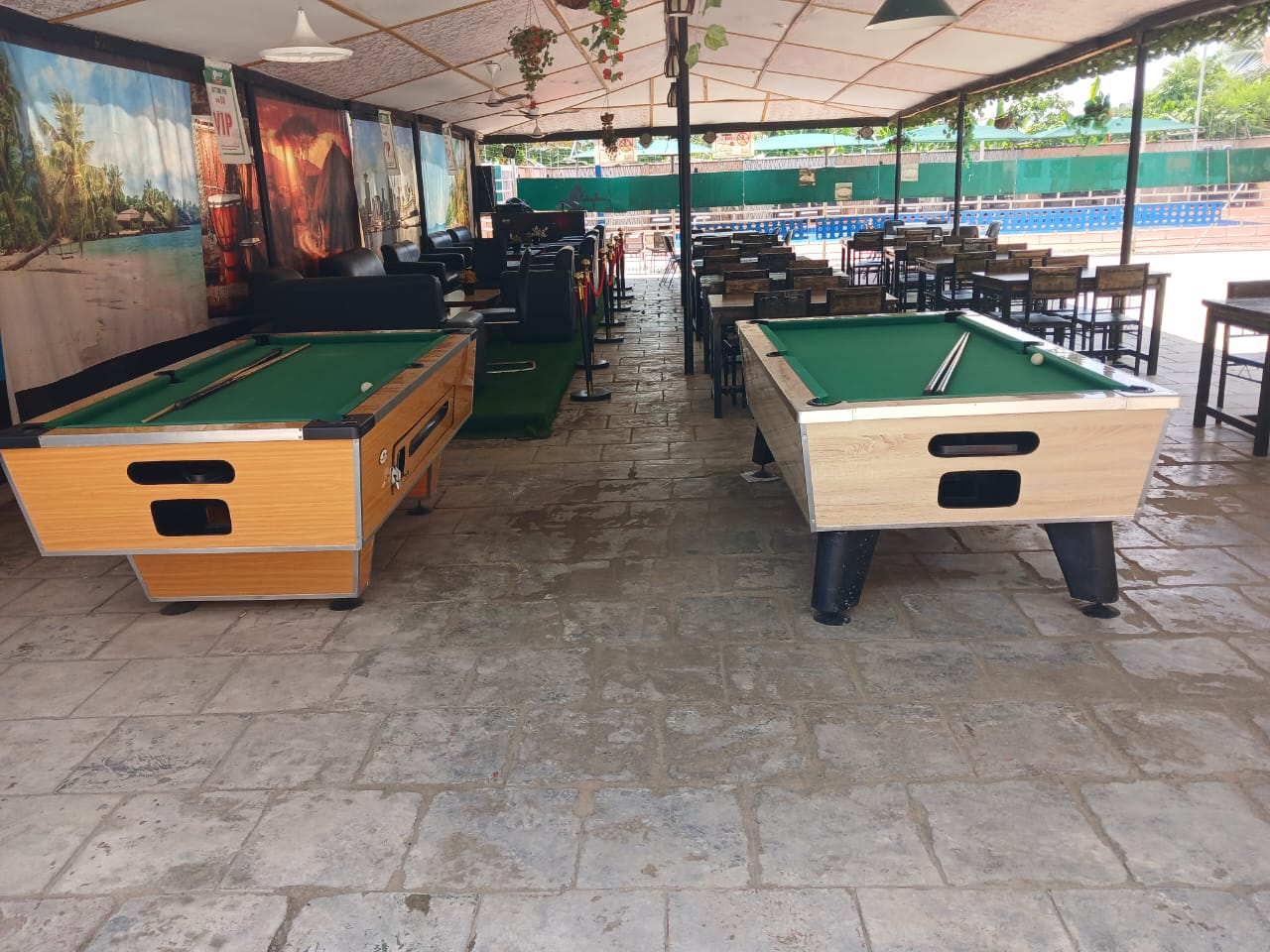 Pool tables and lounge seating beside the pool
